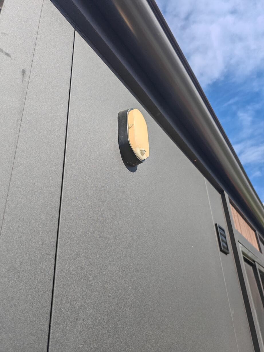 Standing-seam steel roof with black Bondor cladding and timber accent